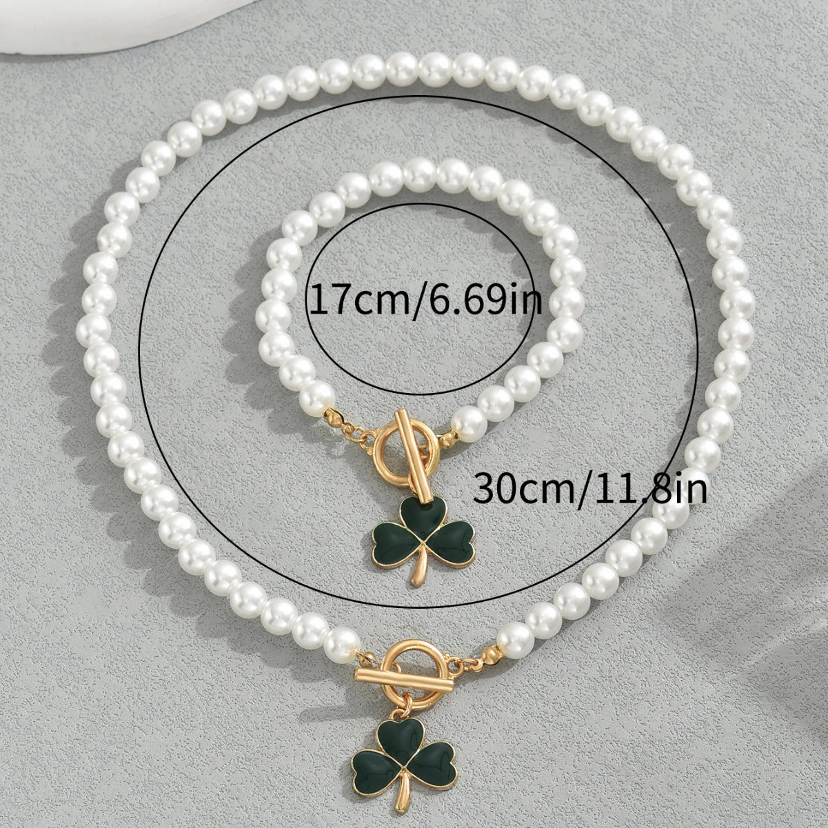 heart and clover pearl jewelry set with white pearl necklace and bracelet featuring green clover charms and gold toggle clasp