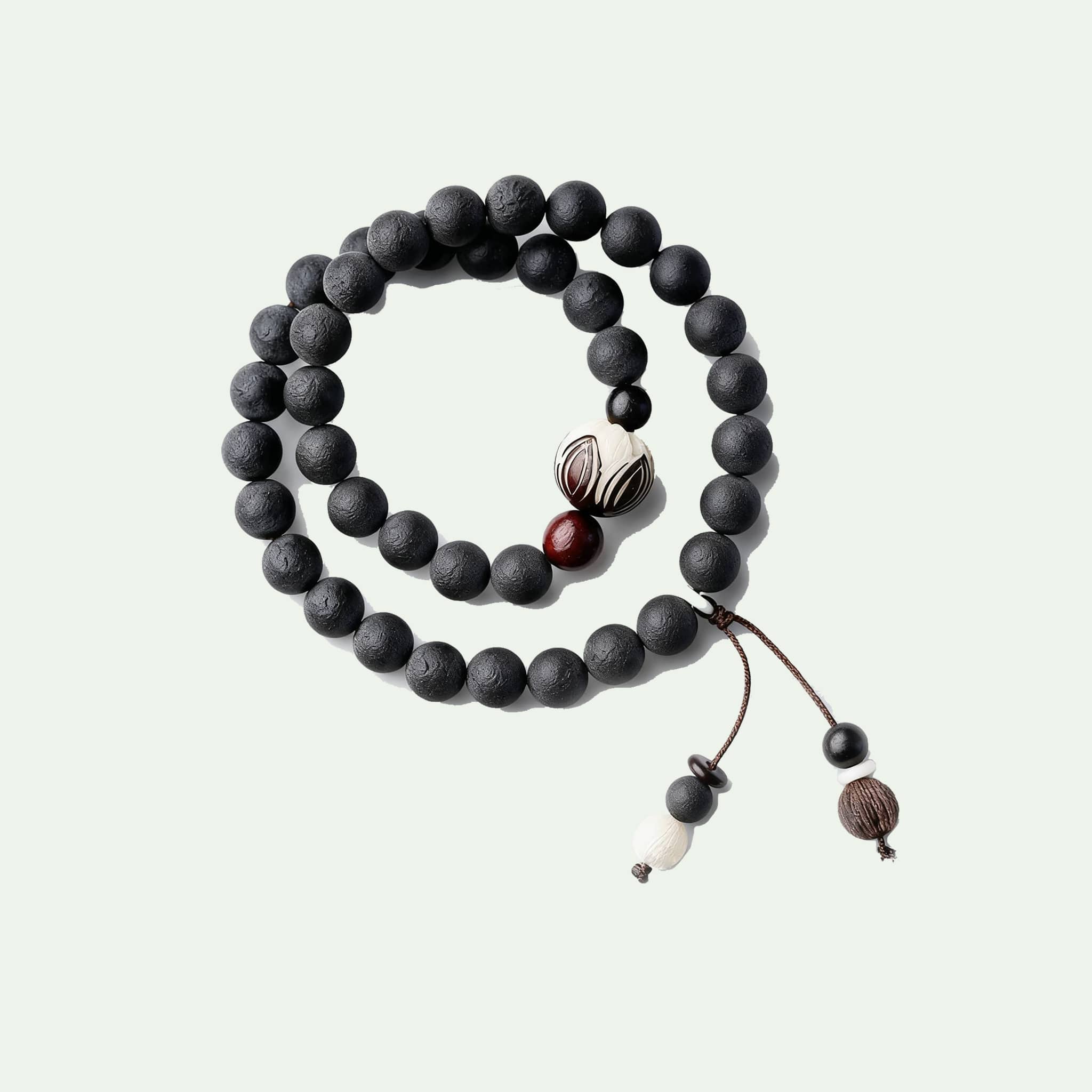 Black amber double wrap bracelet featuring wooden beads and decorative accents for a calming effect