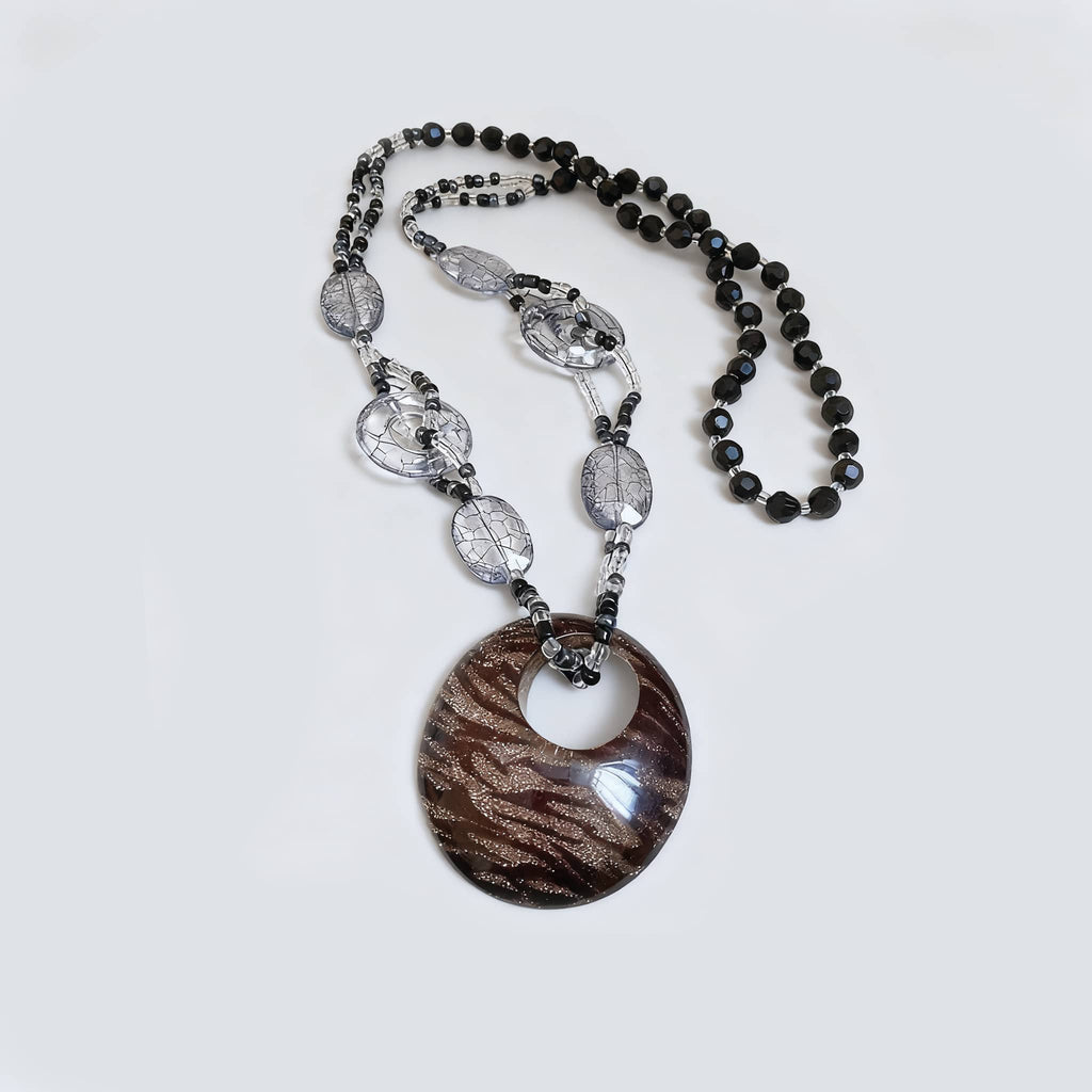 Black leopard pendant necklace with intricate patterns and beaded accents for a stylish look