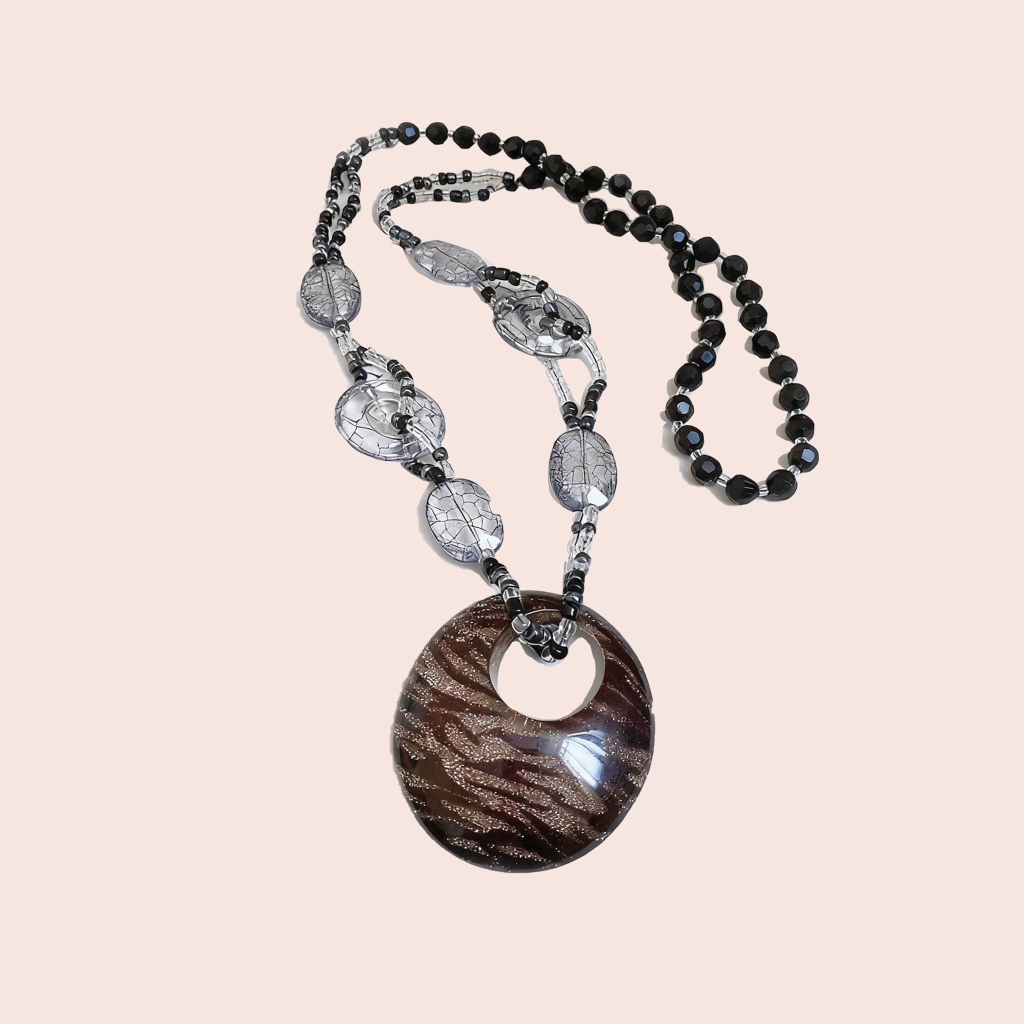 Black leopard pendant necklace with textured oval pendant and intricate bead design from 5 Senses