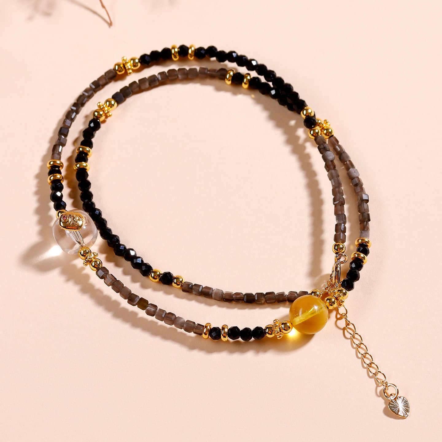 Elegant black obsidian spinel anxiety choker with gold beads and a decorative charm for calming energy