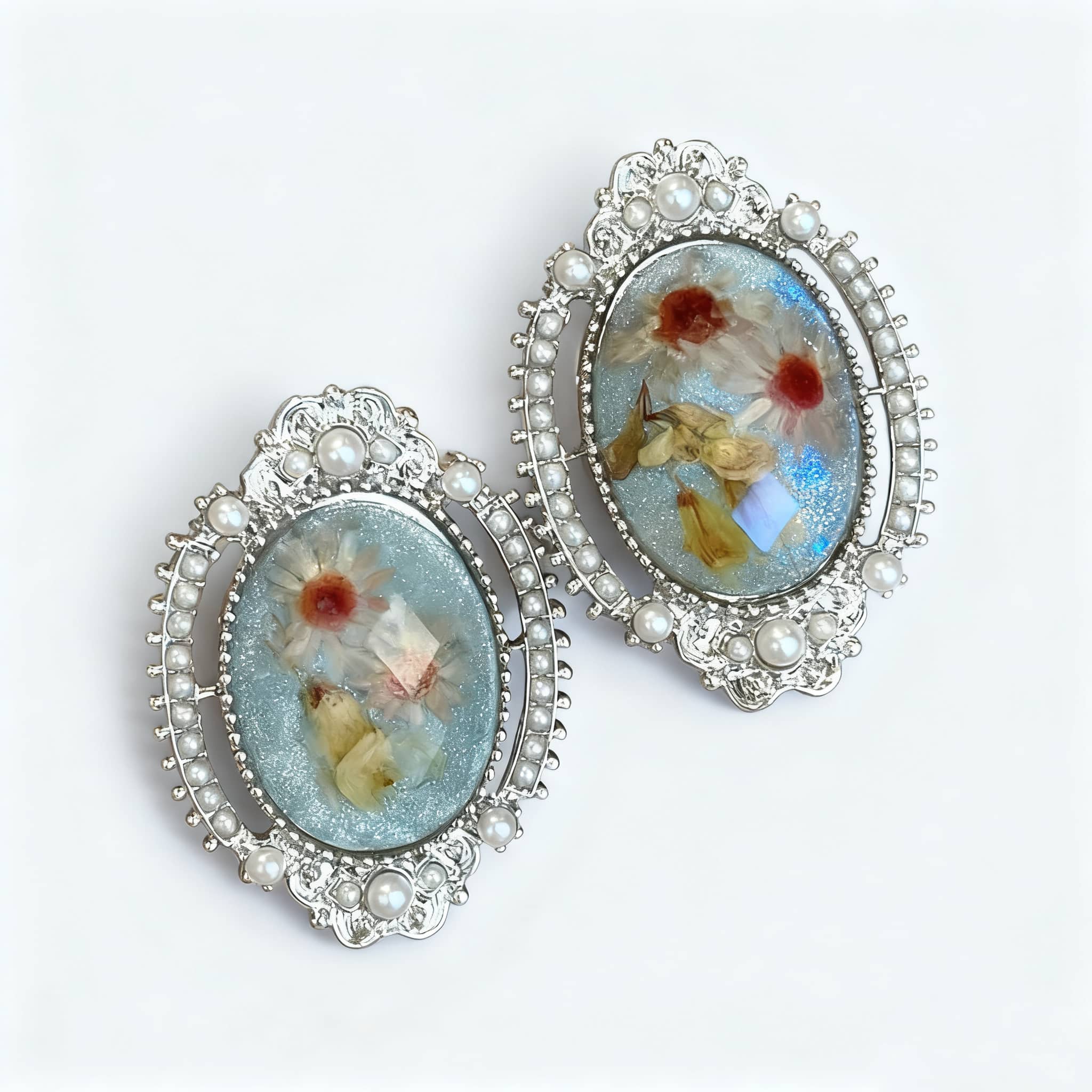 Elegant blue amber earrings for women with floral designs and pearl accents