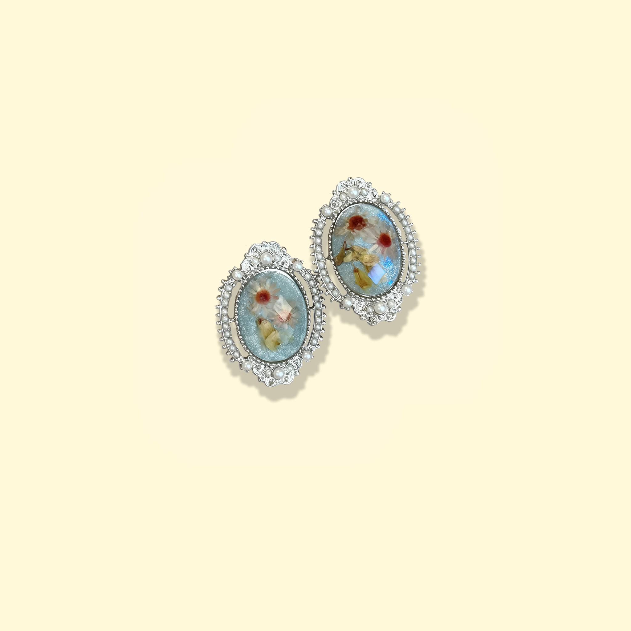 Elegant blue amber earrings for women with intricate silver detailing and floral design