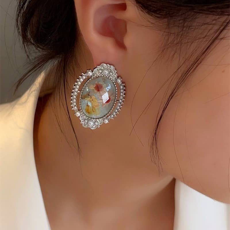 Elegant blue amber earrings for women featuring a floral design with sparkling accents