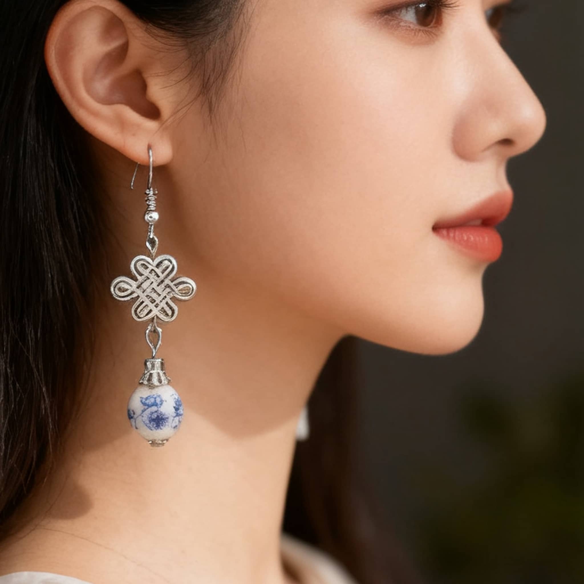 Elegant blue and white ceramic knot earrings with silver accents, perfect for any outfit