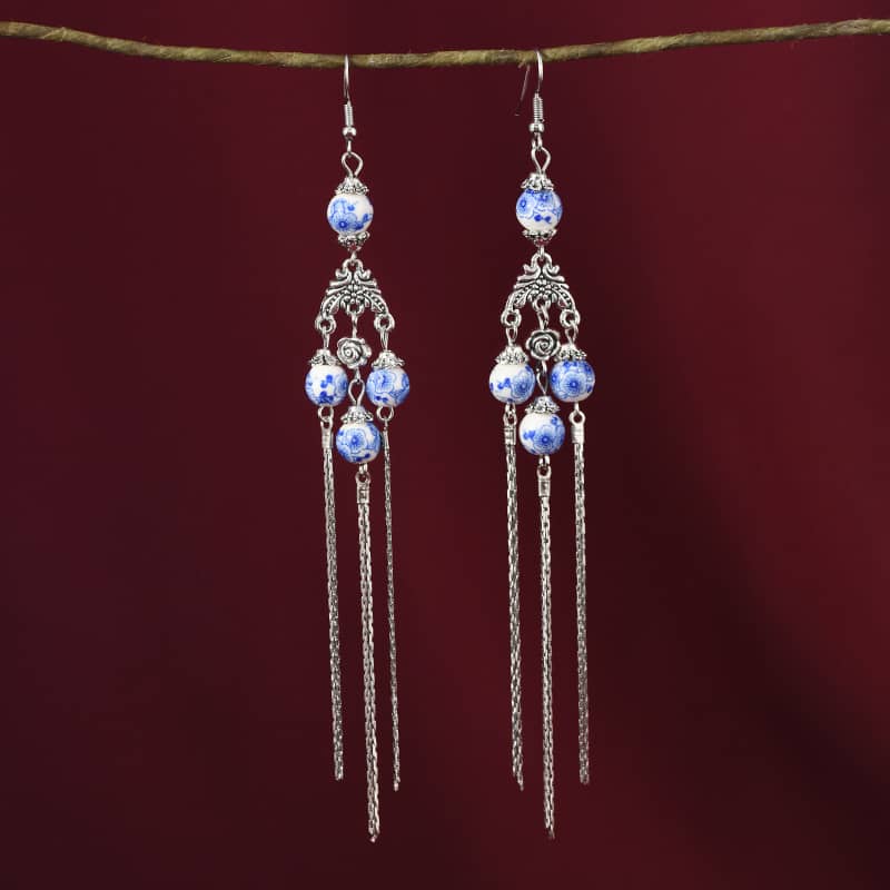 Blue and white porcelain tassel earrings with elegant silver chains and intricate designs