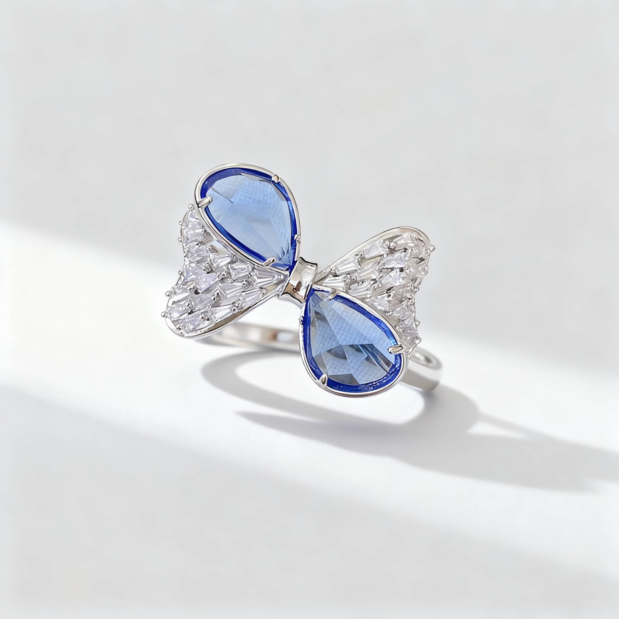 Stunning blue zircon bow ring with intricate silver detailing and a unique butterfly design