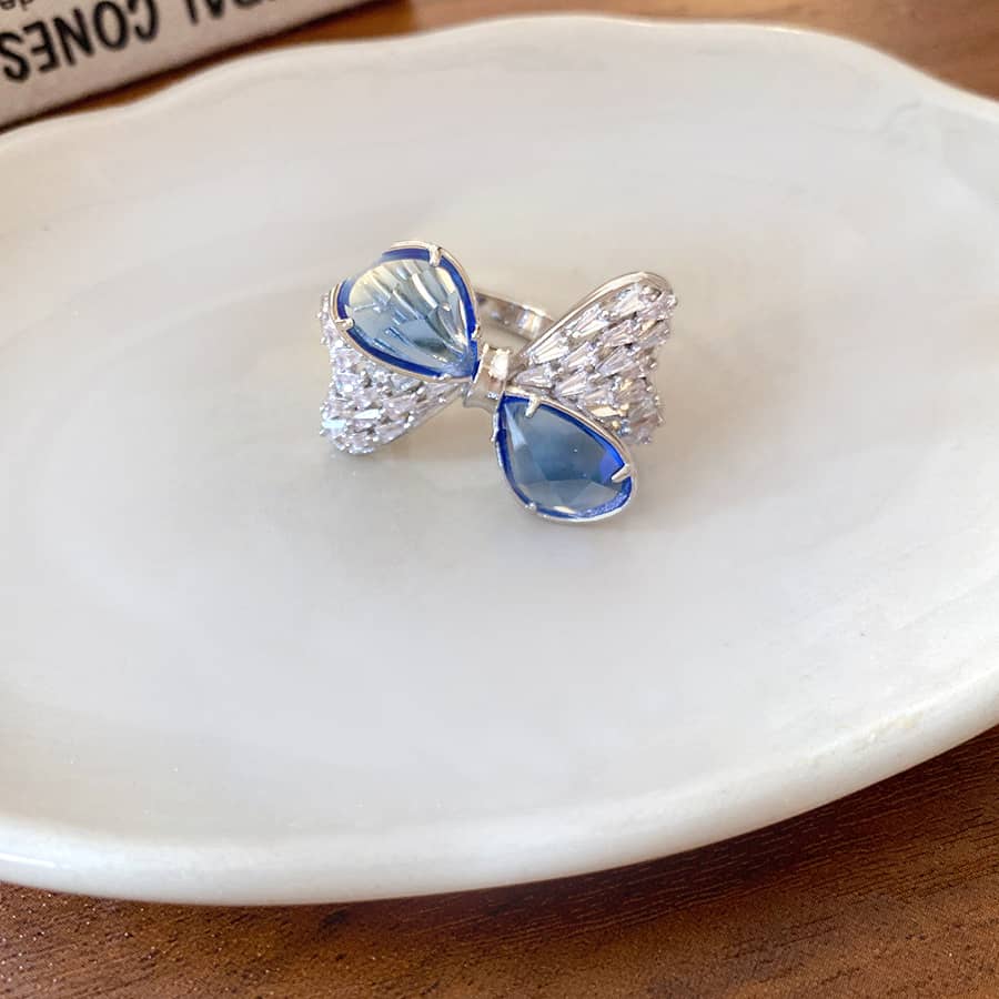 5 Senses blue zircon bow ring featuring sparkling accents on a delicate band