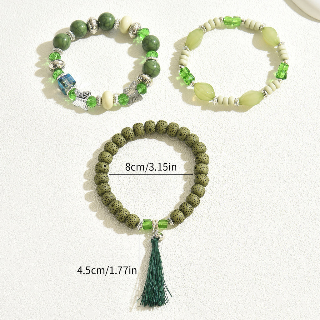 Green beaded bracelet trio including lava bead tassel bracelet and two gemstone stretch bracelets with size overlay
