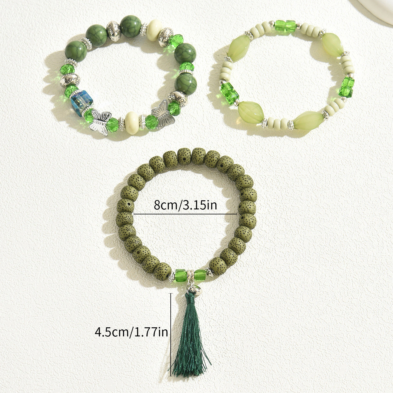 Green beaded bracelet trio including lava bead tassel bracelet and two gemstone stretch bracelets with size overlay