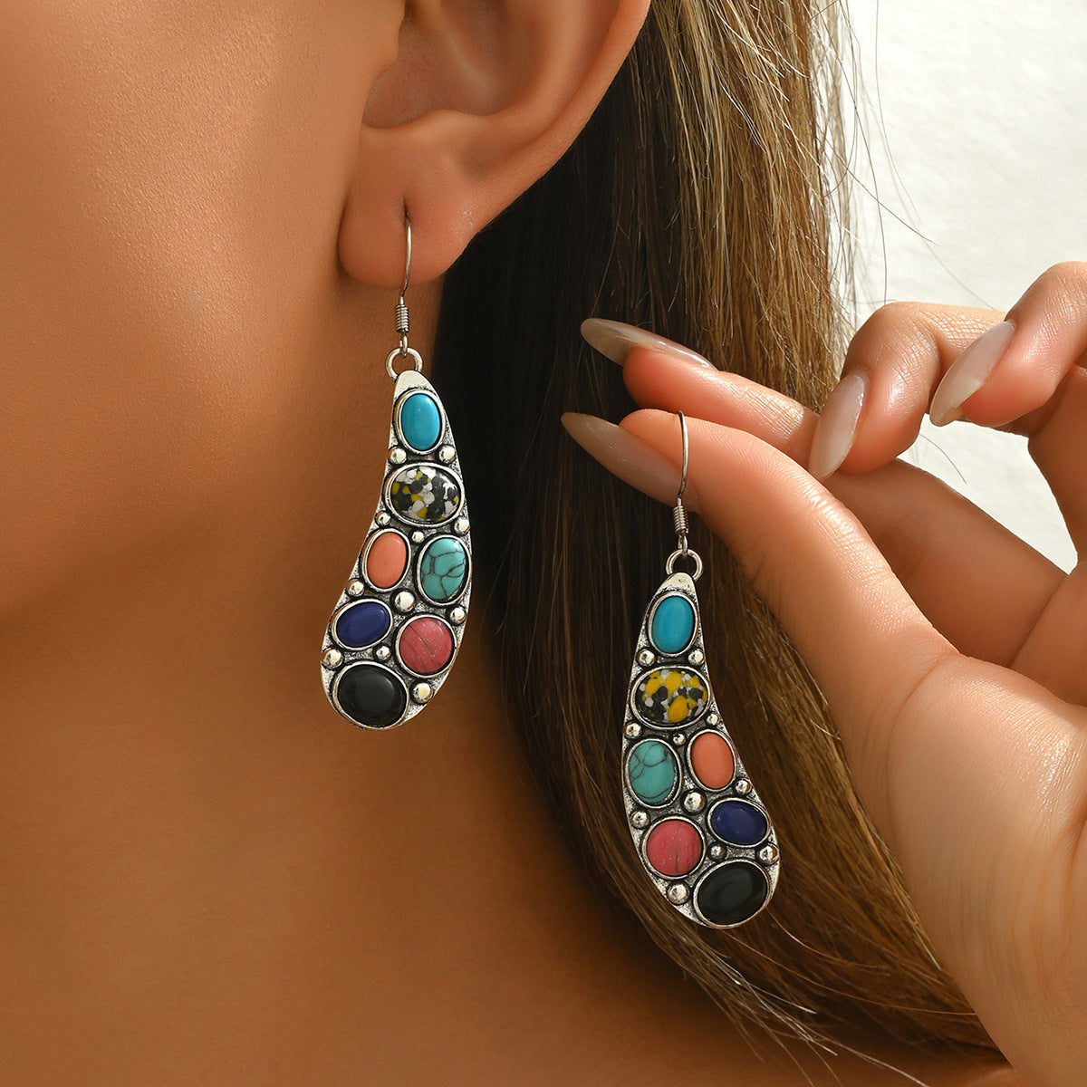 Model wearing colorful natural stone earrings teardrop silver dangles with turquoise coral black blue and yellow accents