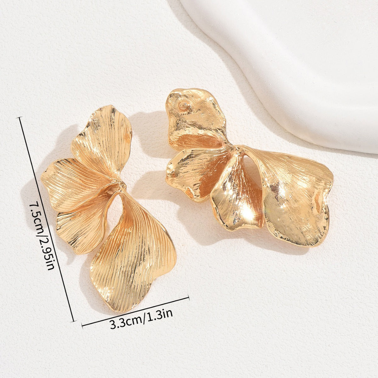 Bold gold flower earrings with textured petals measuring 7.5cm by 3.3cm in a shiny finish