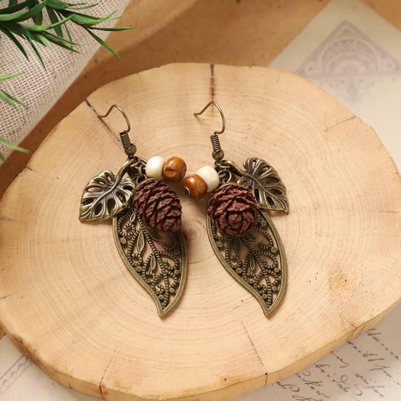 Botanical earrings with pinecone featuring leaf designs and wooden beads for stylish accessories