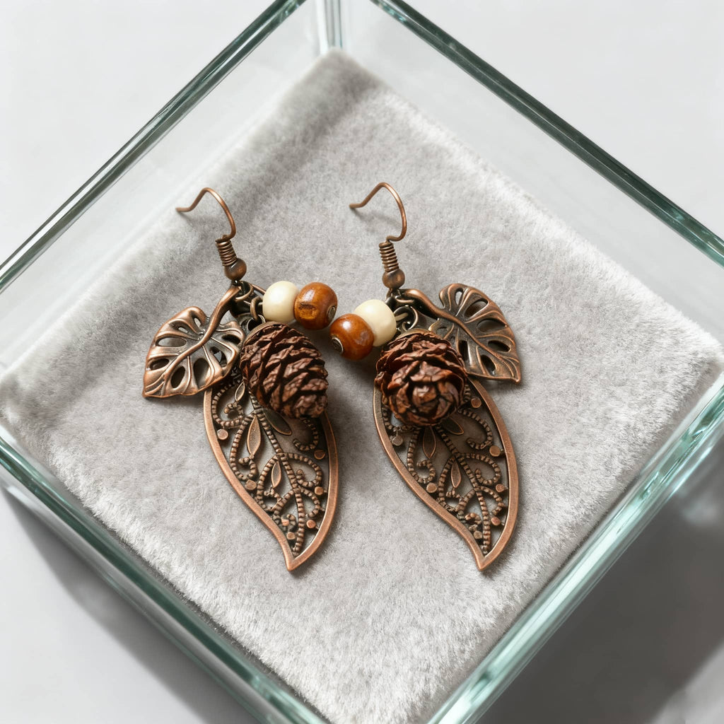 Botanical earrings with pinecone featuring intricate leaf details and decorative beads