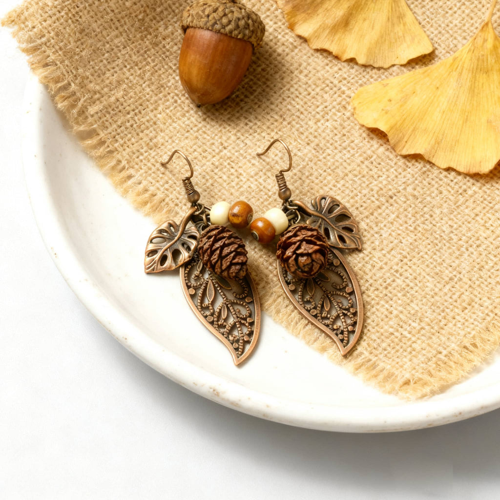 Botanical earrings with pinecone featuring delicate leaf designs and earthy tones