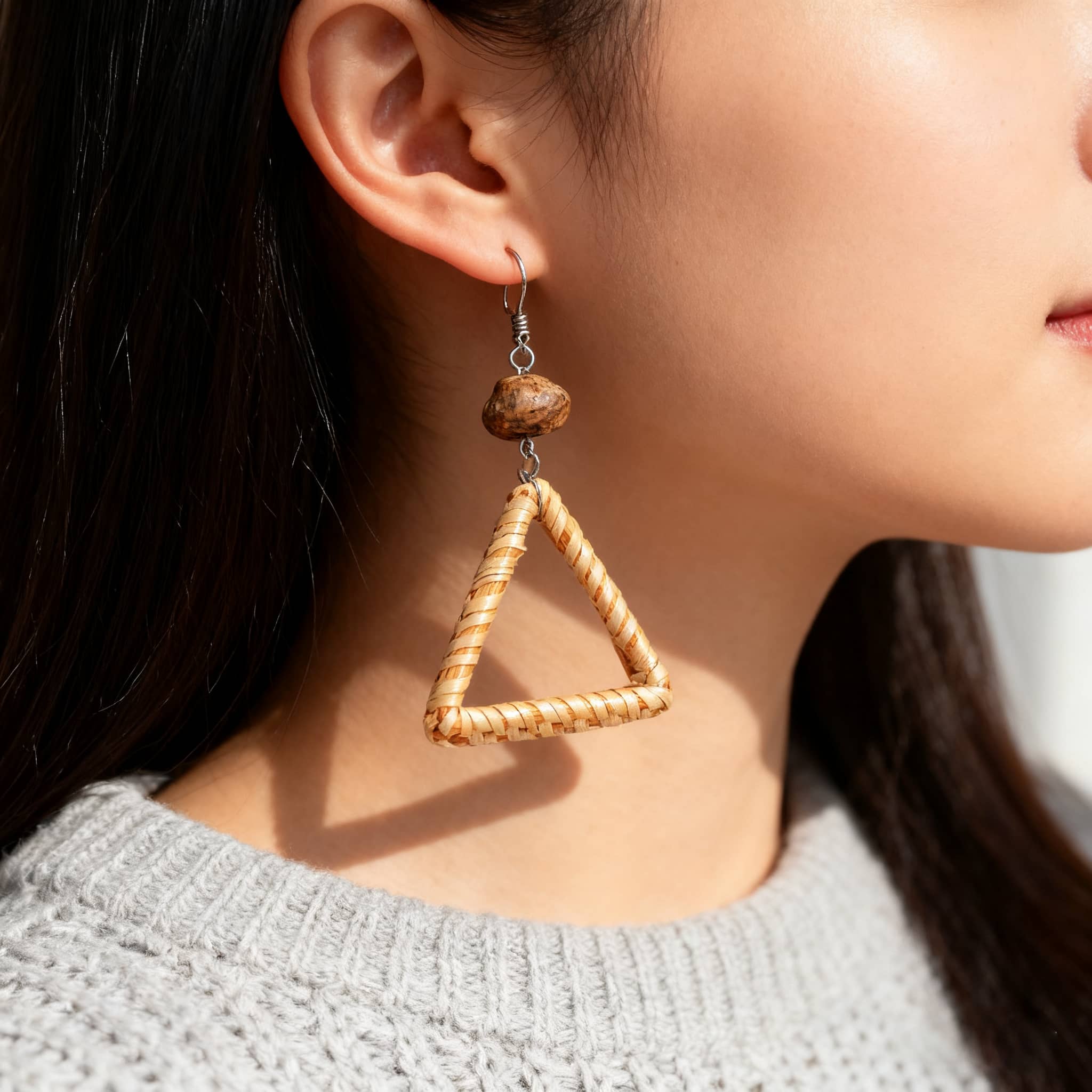 Calm woven triangle earrings with a wooden bead, perfect for a stylish and natural look
