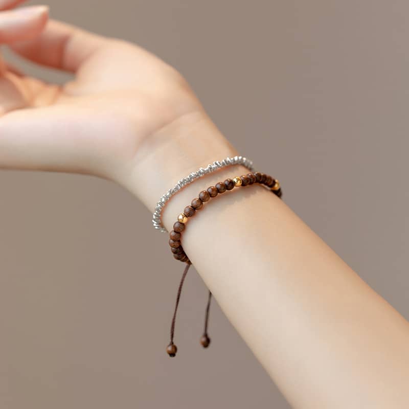 Calming silkwood gold bead bracelet elegantly displayed on a person's wrist with a neutral background