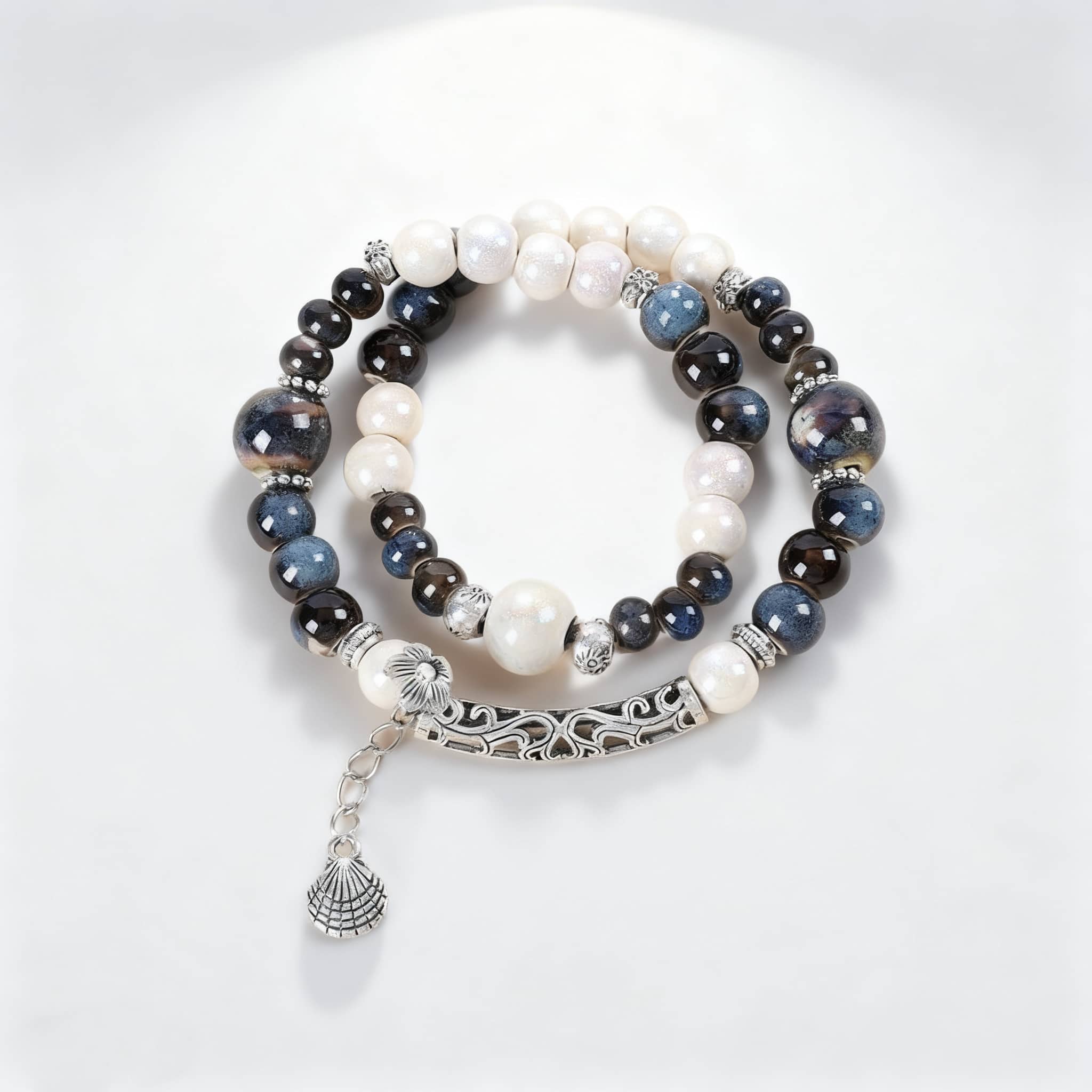 5 Senses ceramic and shell bracelet for self-care featuring elegant beads and a decorative charm