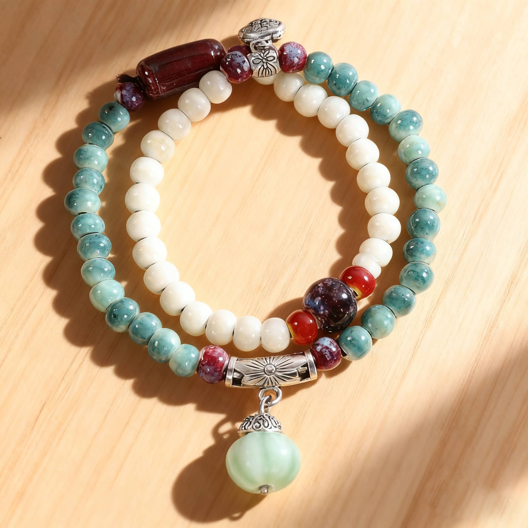 5 Senses ceramic bead stacking bracelets featuring colorful beads and a decorative charm