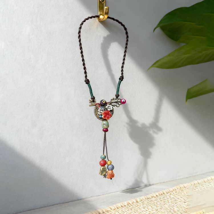 Handcrafted ceramic key necklace for self-care with colorful beads and intricate design