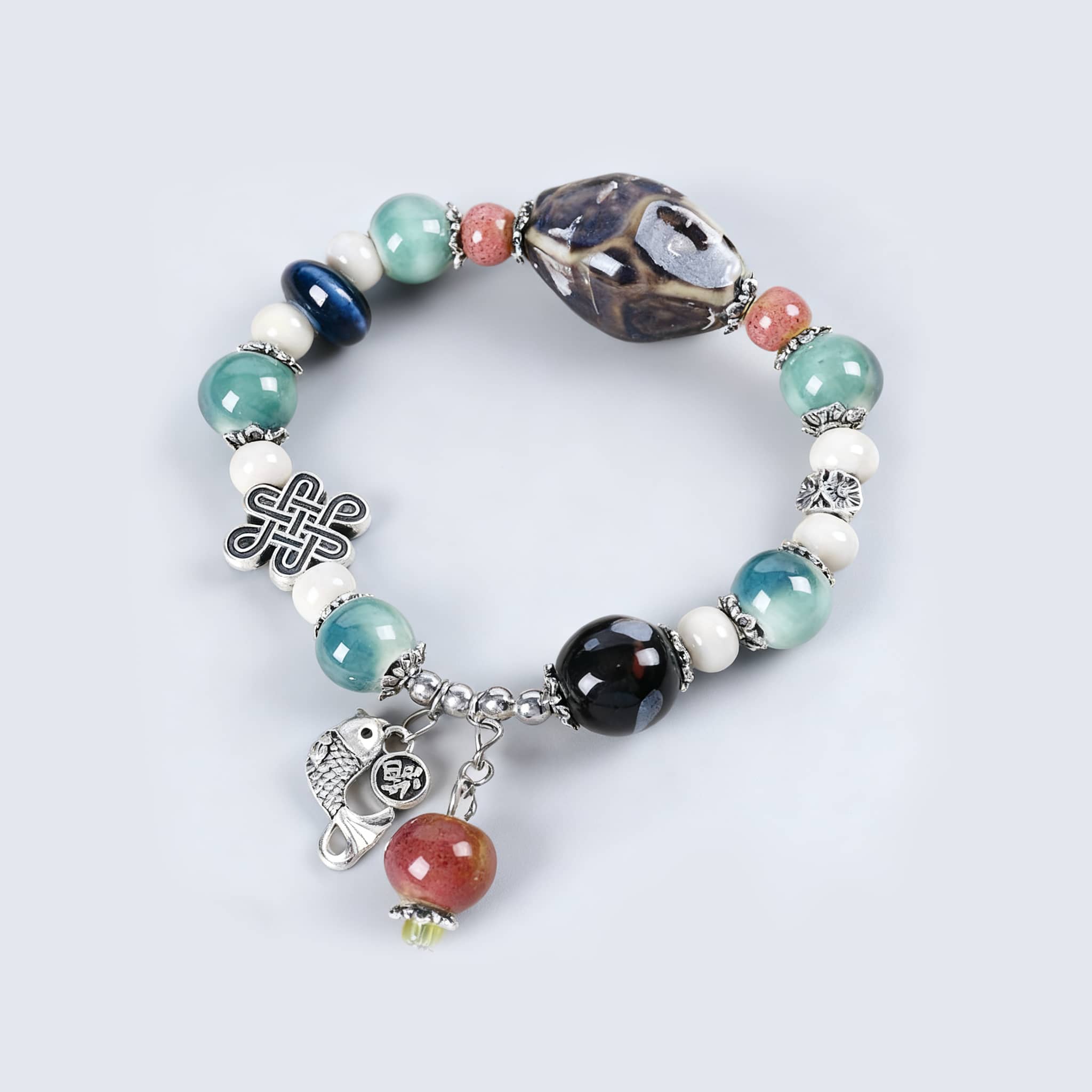 Colorful ceramic persimmon bracelet featuring unique beads and a charm for a stylish accessory