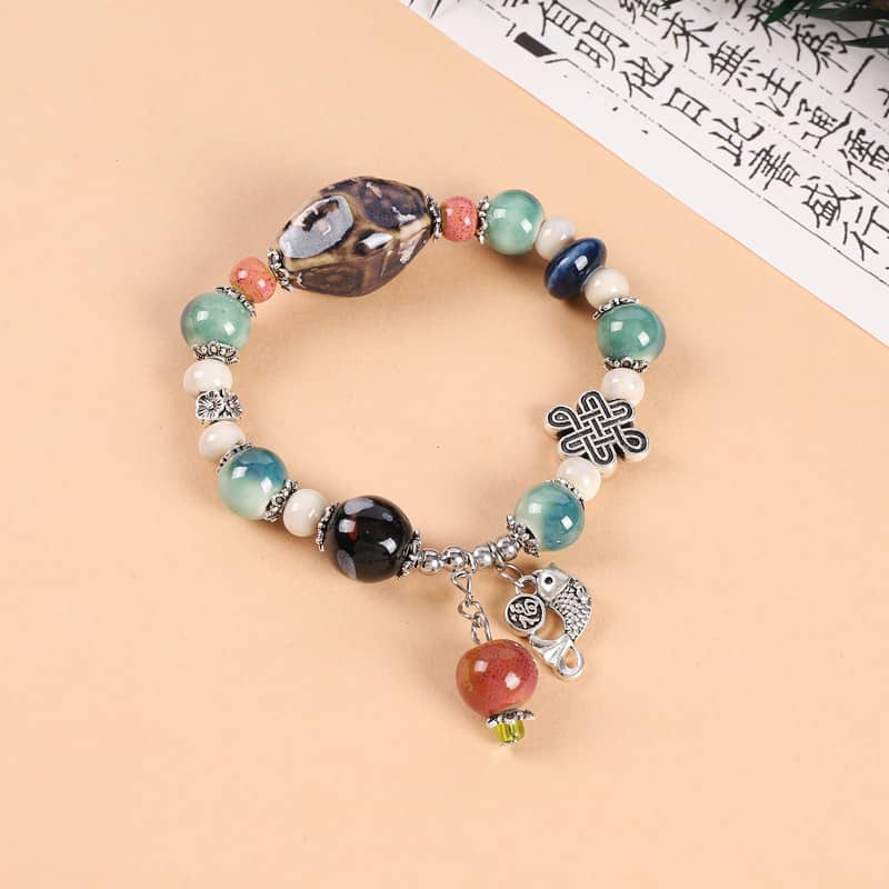 Colorful ceramic persimmon bracelet featuring unique beads and charms for stylish accessory lovers