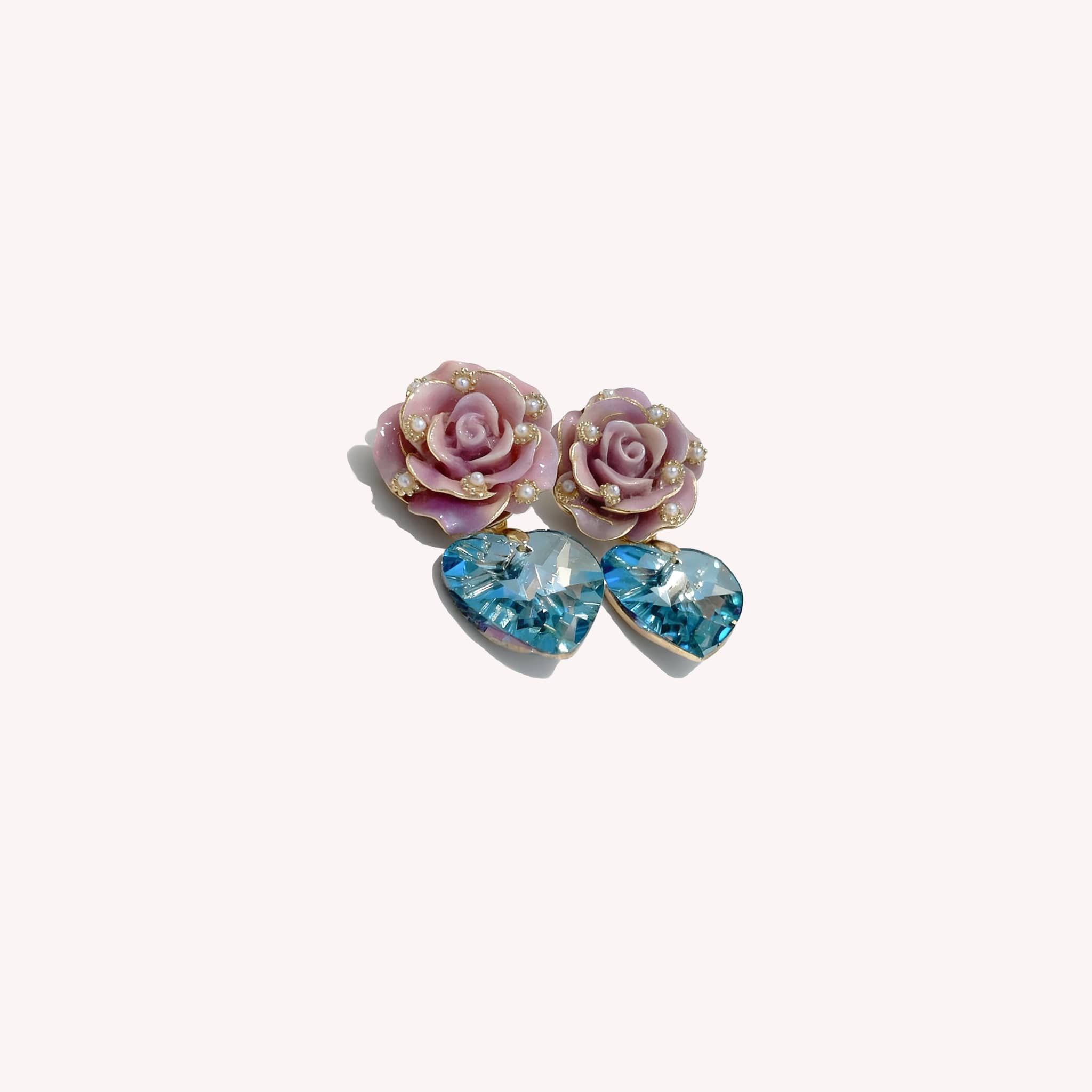 5 Senses ceramic rose zircon earrings featuring pink rose designs and blue heart-shaped zircon stones