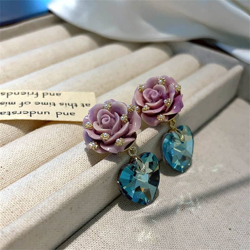 Beautiful ceramic rose zircon earrings featuring pink roses and sparkling heart-shaped blue stones