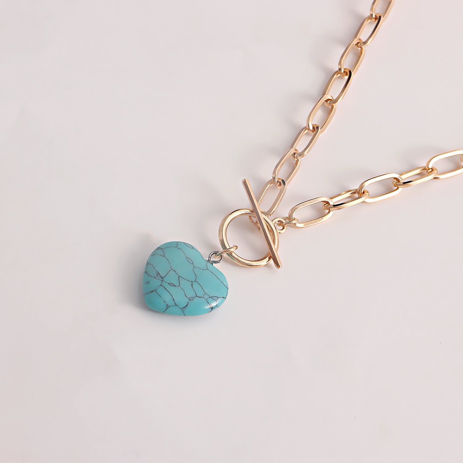 Gold chain bracelet with blue clay heart pendant jewelry featuring a toggle clasp