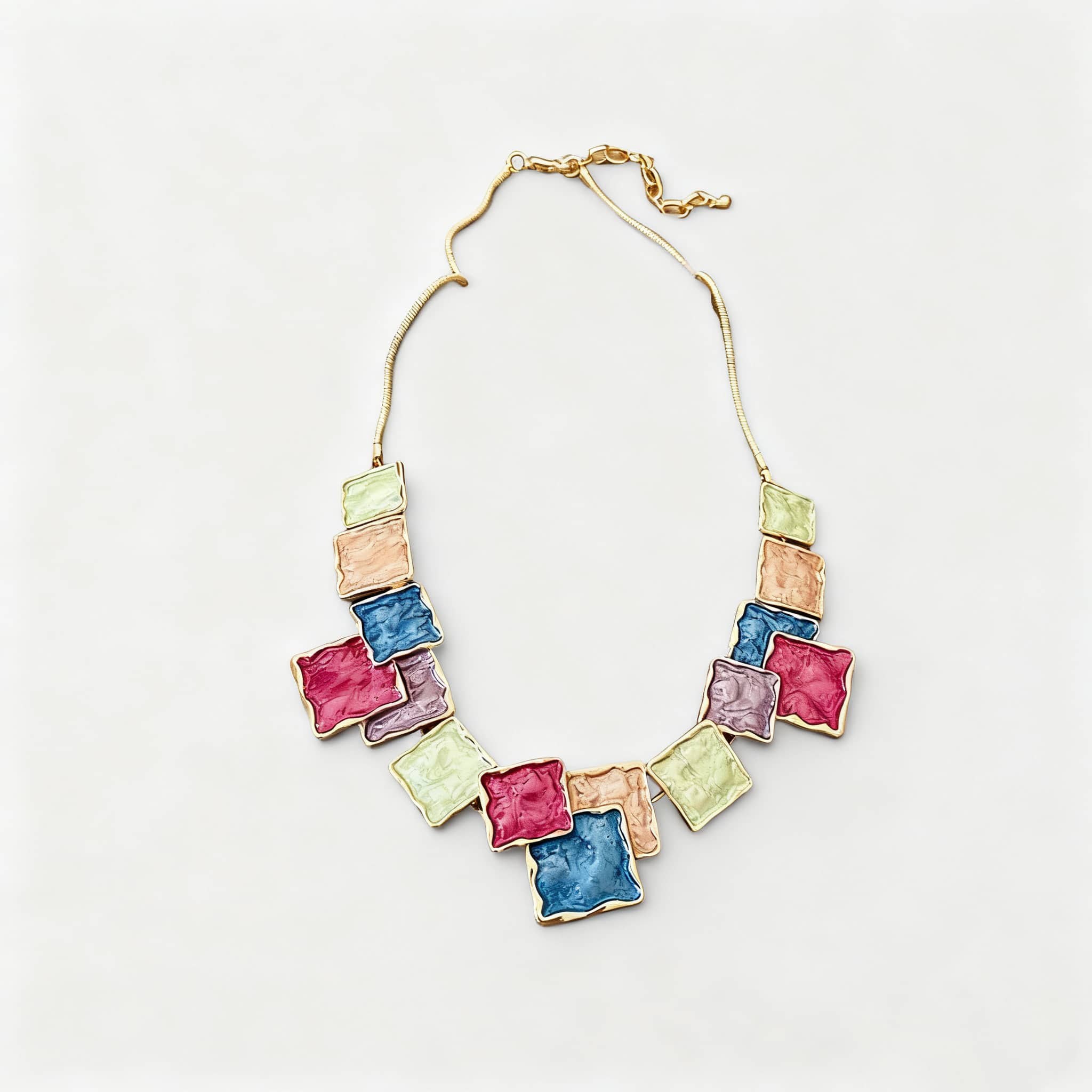 Color blocked asymmetrical necklace featuring colorful square-shaped charms and a gold chain for a trendy look