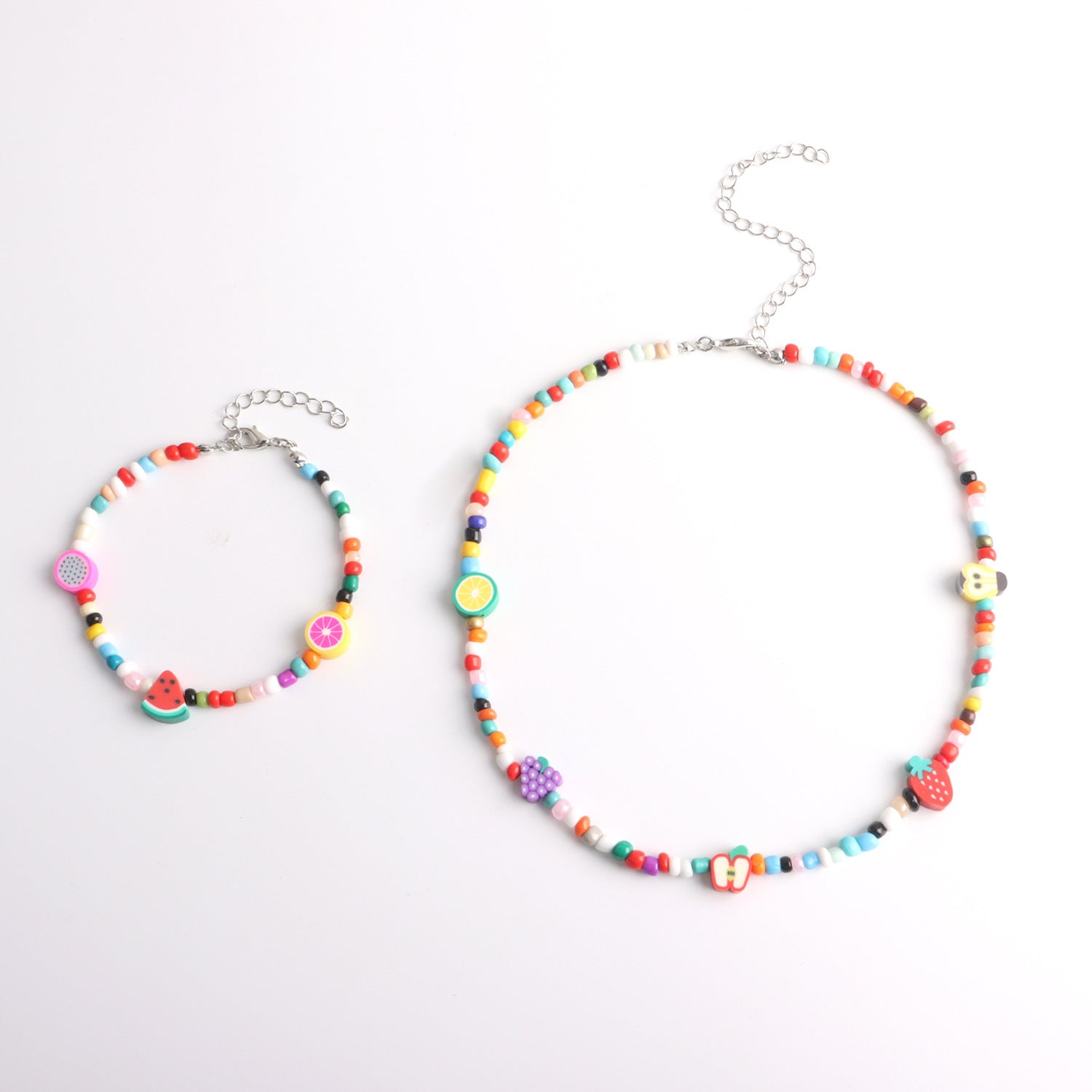Colorful beaded necklace and bracelet set with fruit-shaped charms and adjustable silver chains