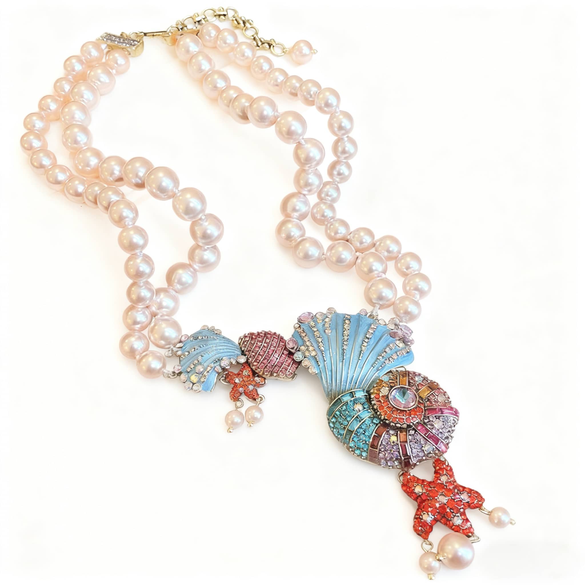 Elegant conch and pearl necklace featuring colorful shell designs and sparkling embellishments