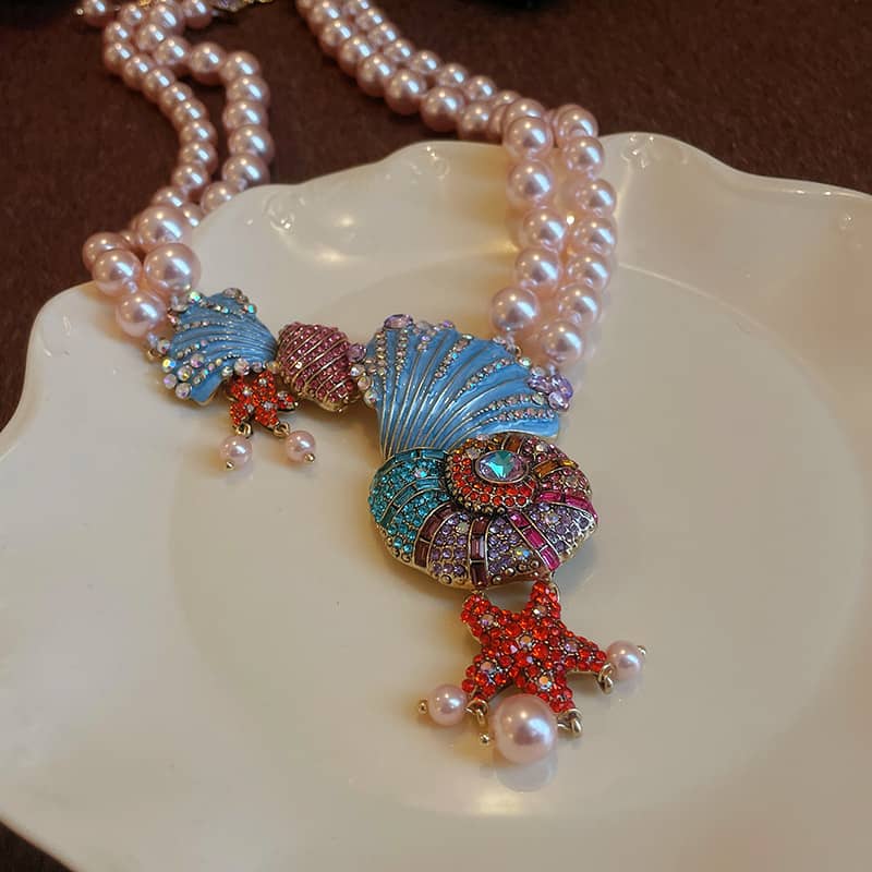 Elegant conch and pearl necklace featuring colorful shell and starfish designs with pearl accents