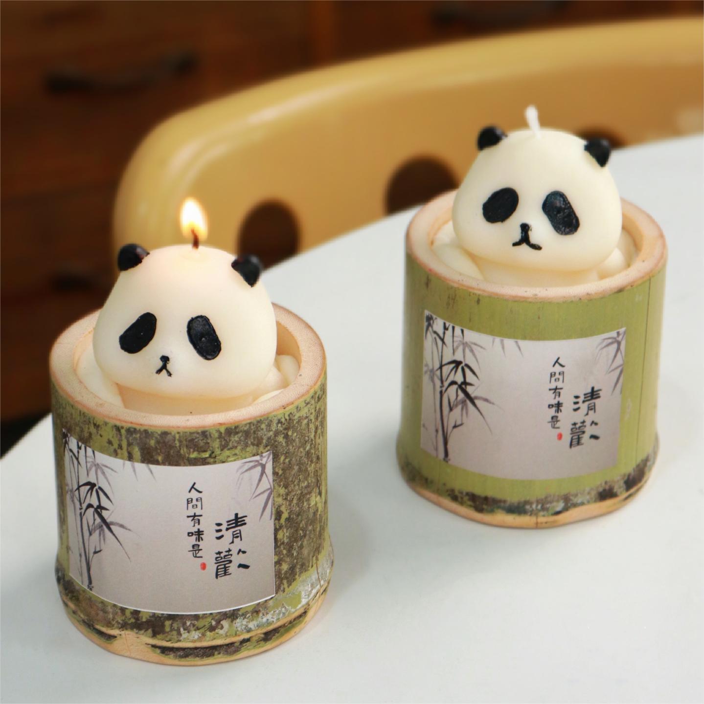 Cute animal themed candle shaped like a panda inside a bamboo-style holder with Asian calligraphy