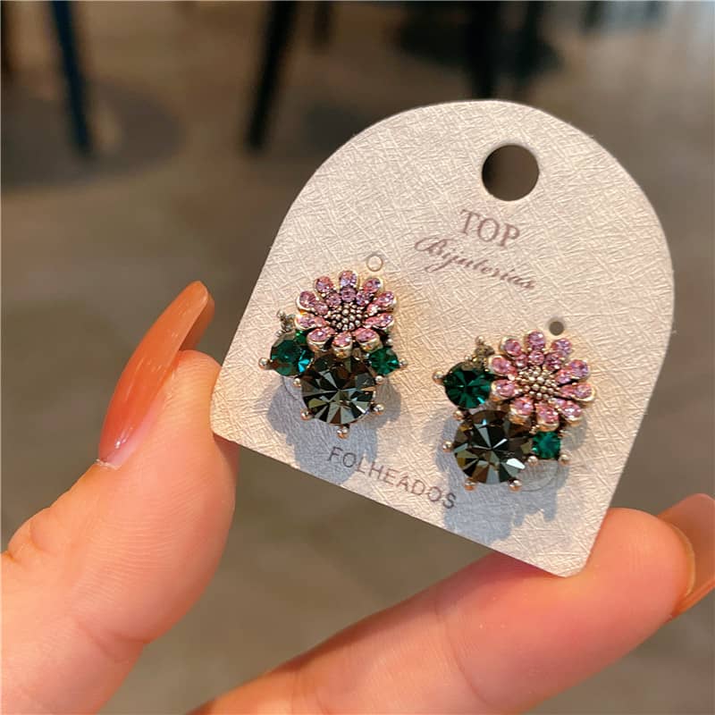 Daisy zircon stud earrings with colorful gemstone accents on elegant card display