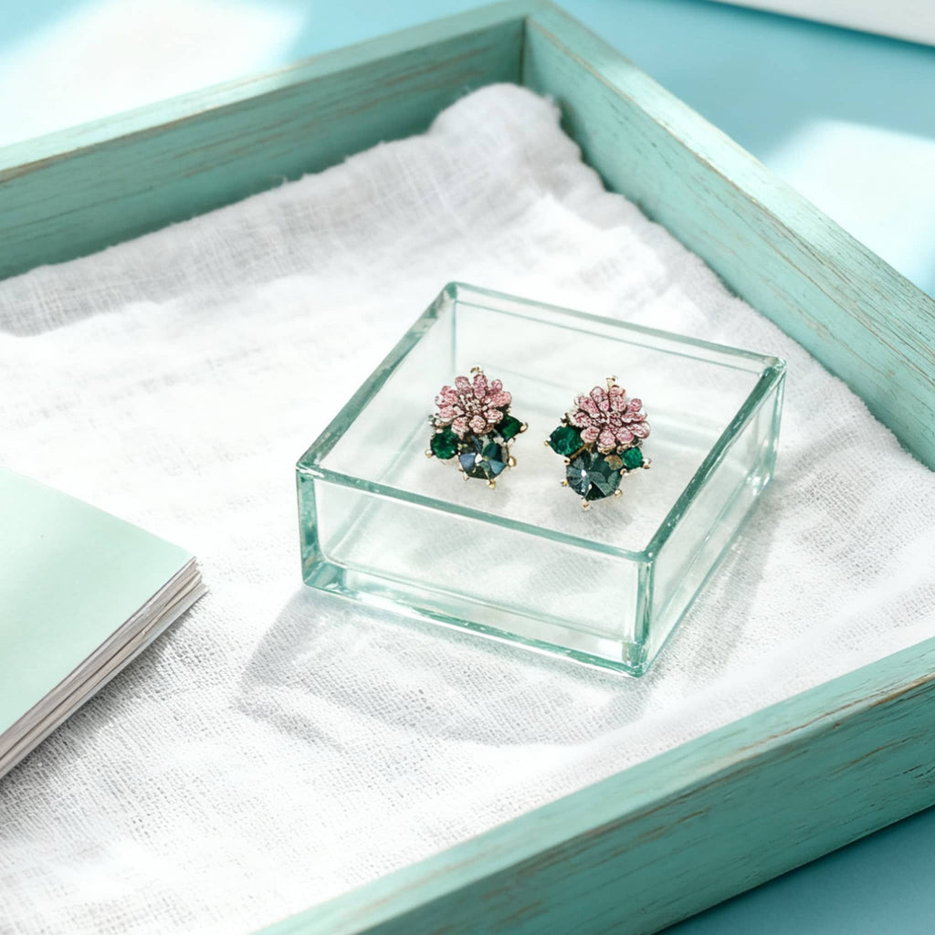 5 Senses daisy zircon stud earrings displayed on a cozy gray scarf with autumn leaves