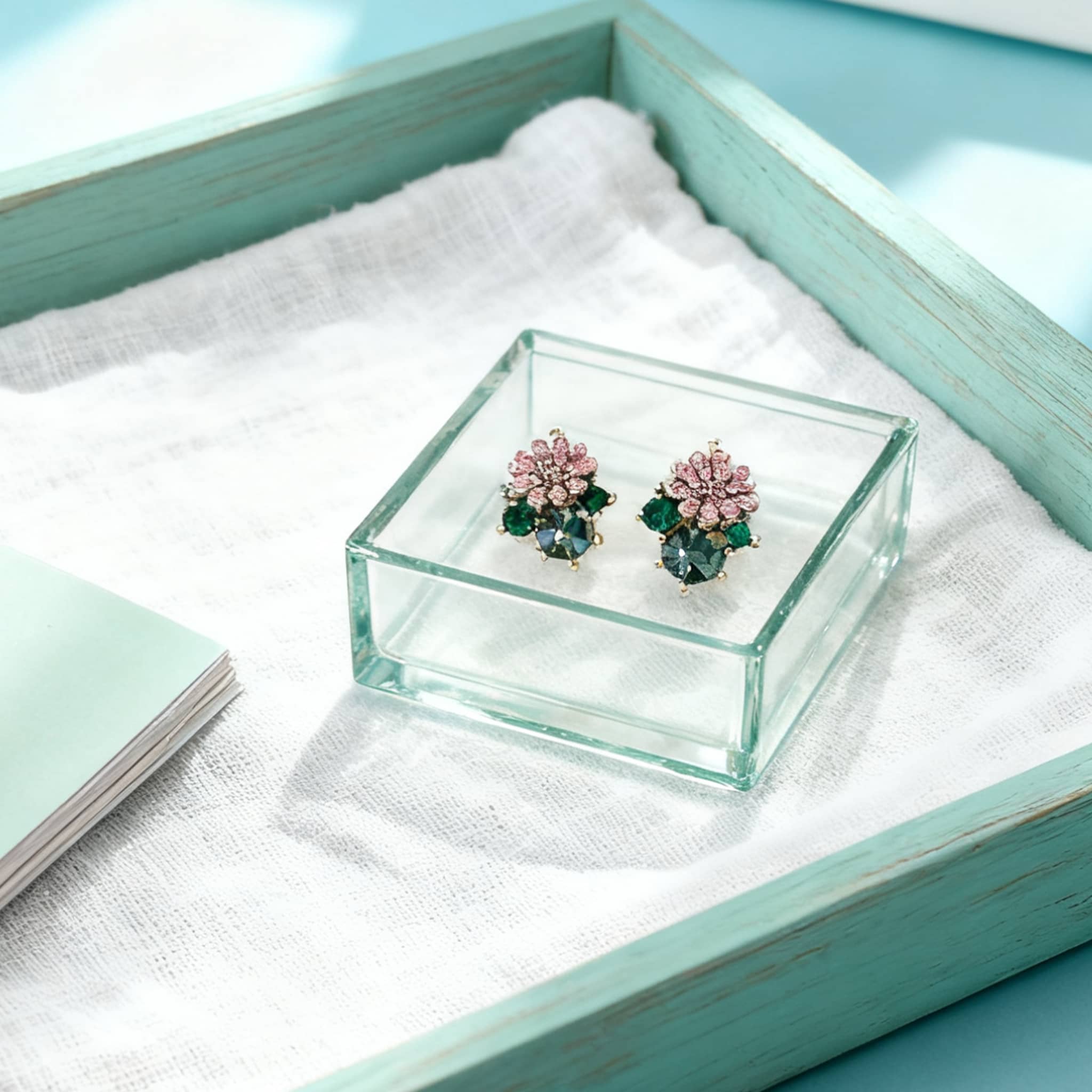 5 Senses daisy zircon stud earrings displayed on a cozy gray scarf with autumn leaves