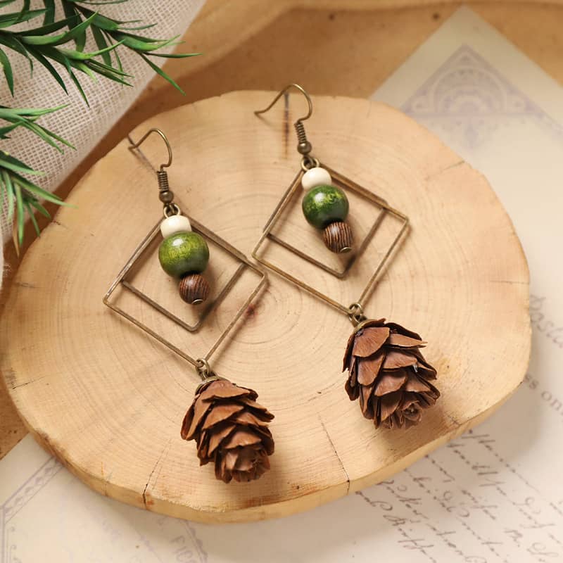 Unique double rhombus statement earrings featuring natural pinecone and green accents