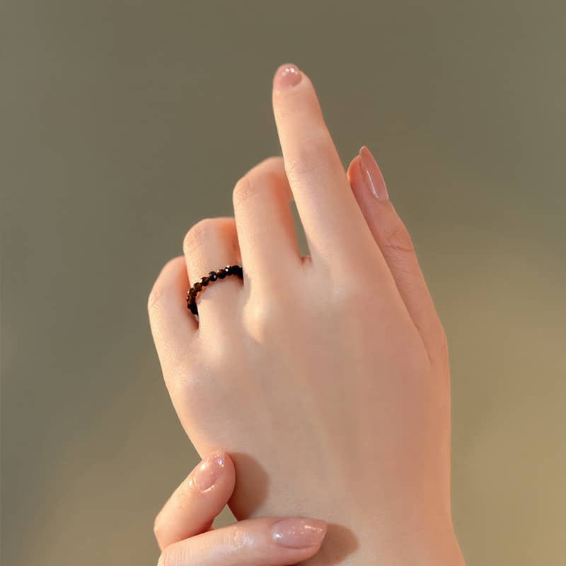 Emotional support gemstone ring displayed on a hand with elegant nails for soothing anxiety