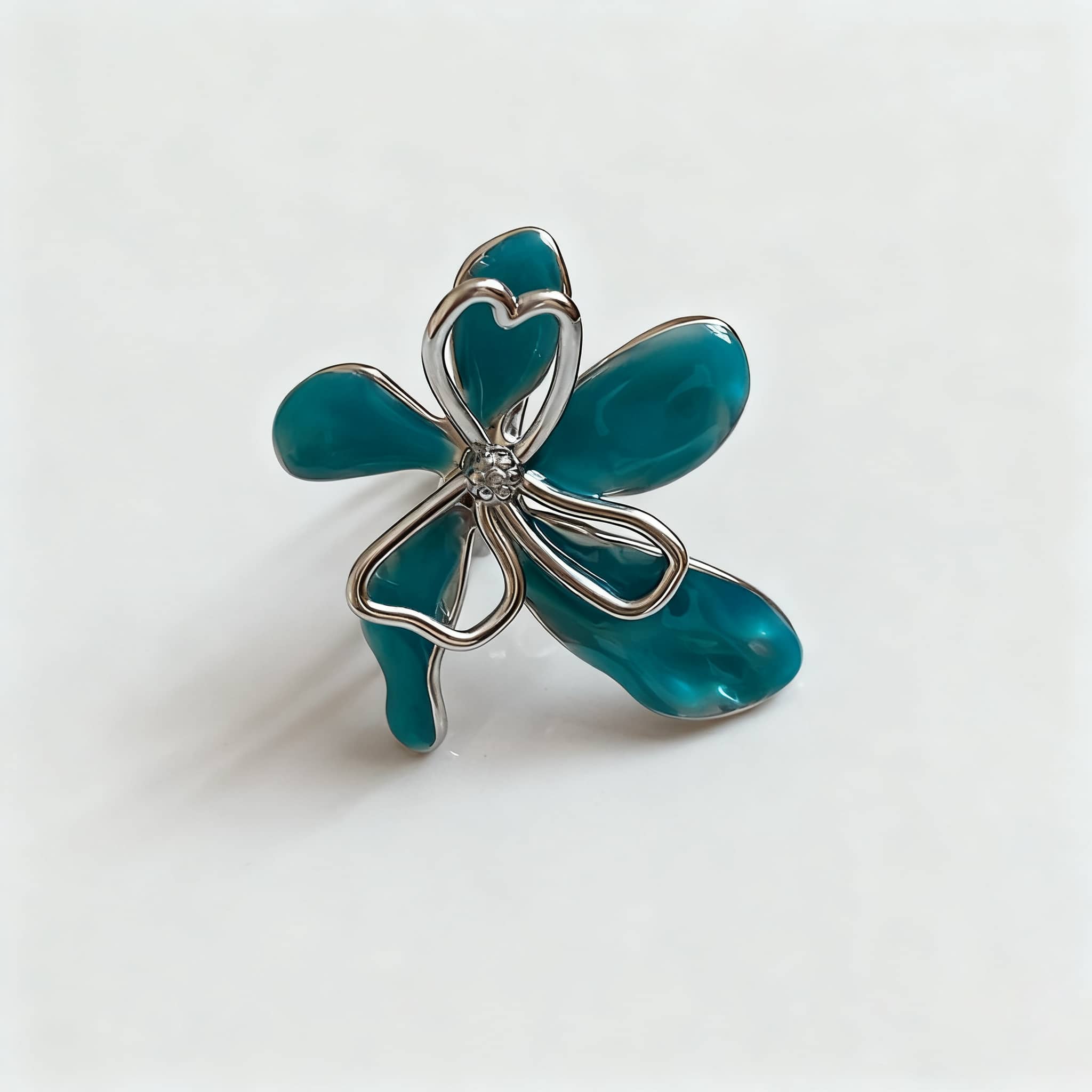 5 Senses enamel flower ring with a teal design and sparkling center stone