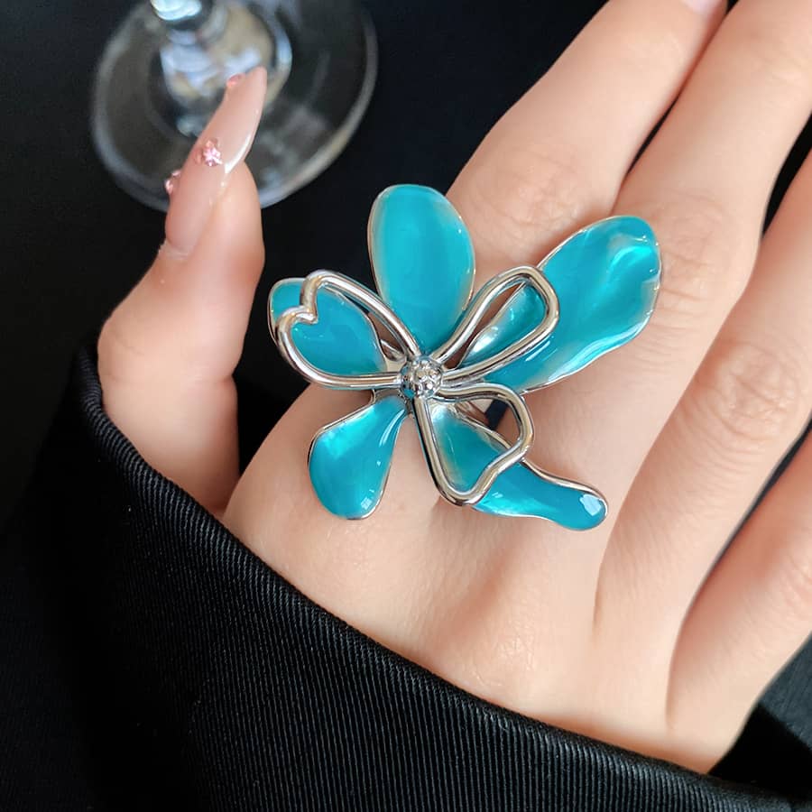 Bright blue enamel flower ring from 5 Senses featuring a delicate silver outline and sparkling center