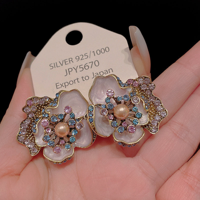 Enamel flower ring with pearl center featuring colorful gemstones and a silver base for an elegant look
