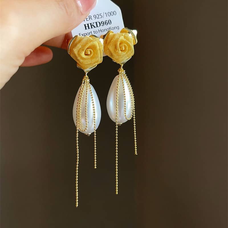 Fabric floral statement earrings with gold chain and teardrop pearl details for a chic look