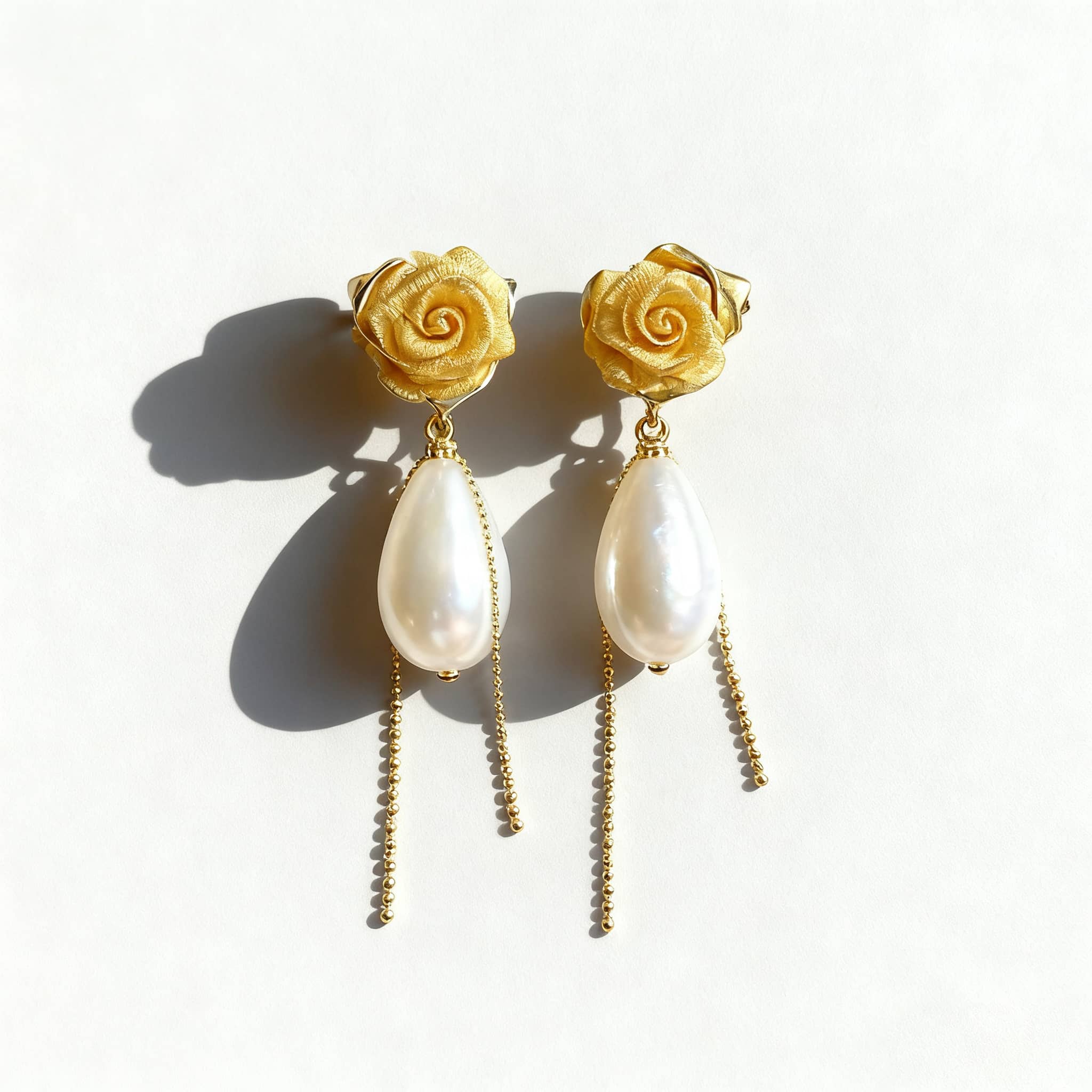 Elegant fabric floral statement earrings featuring golden roses and pearl drops
