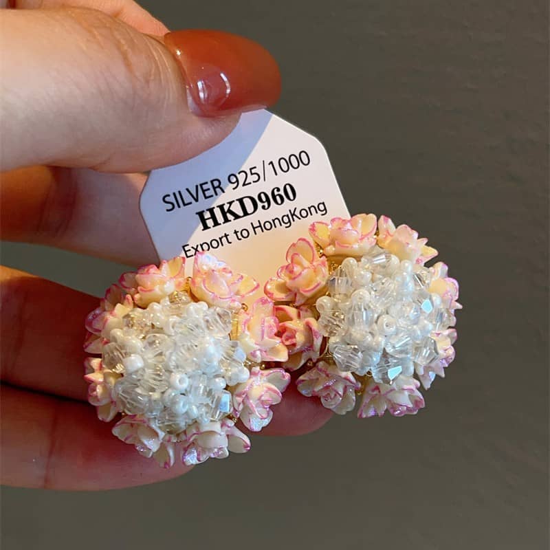Floral bead stud earrings featuring pink and white flower designs crafted from silver