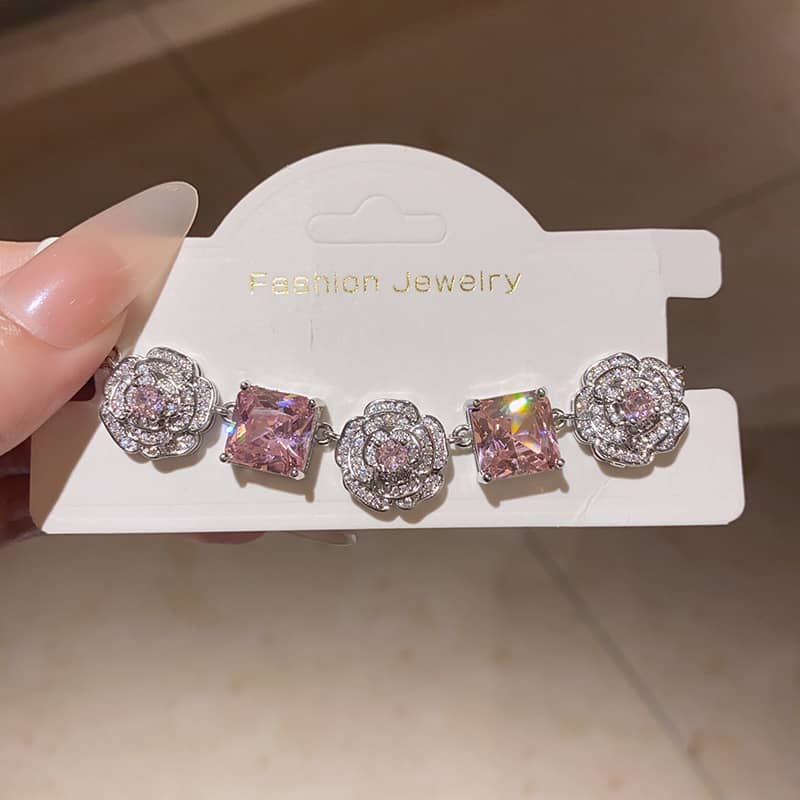 Floral chain bracelet for women featuring pink stones and intricate floral designs