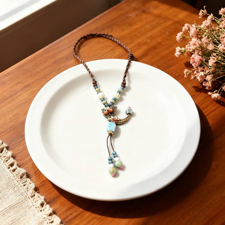Floral moon pendant necklace with colorful beads on a braided brown cord for a unique style