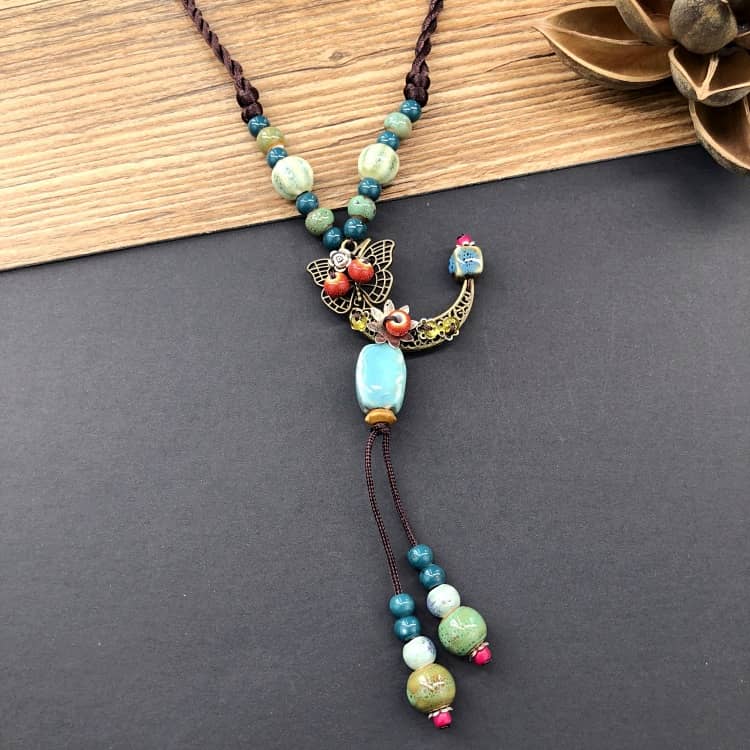 Handcrafted floral moon pendant necklace with colorful beads and intricate detailing