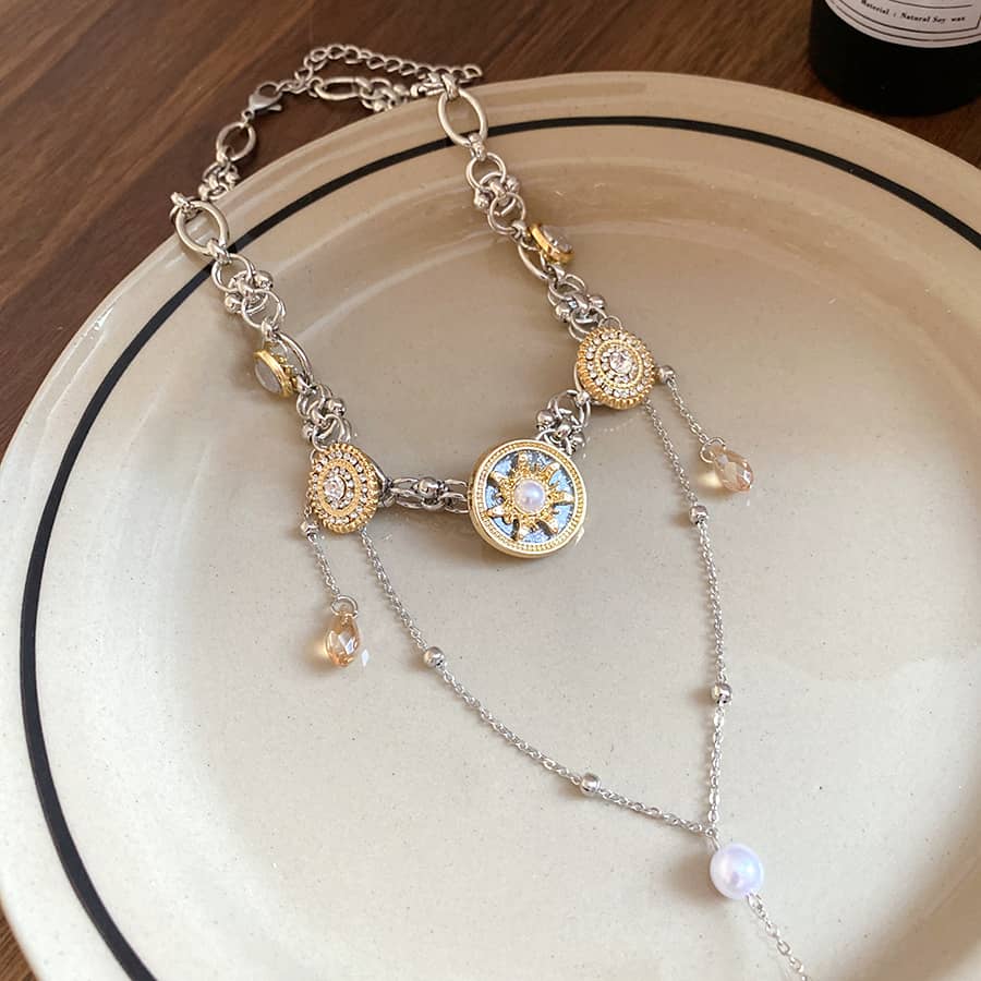 Intricate floral pearl pendant necklace with silver chain and decorative components for elegant styling