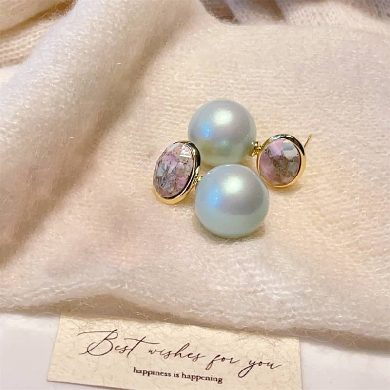Mint pearl ceramic earrings featuring elegant pastel colors and gold accents on a soft fabric background